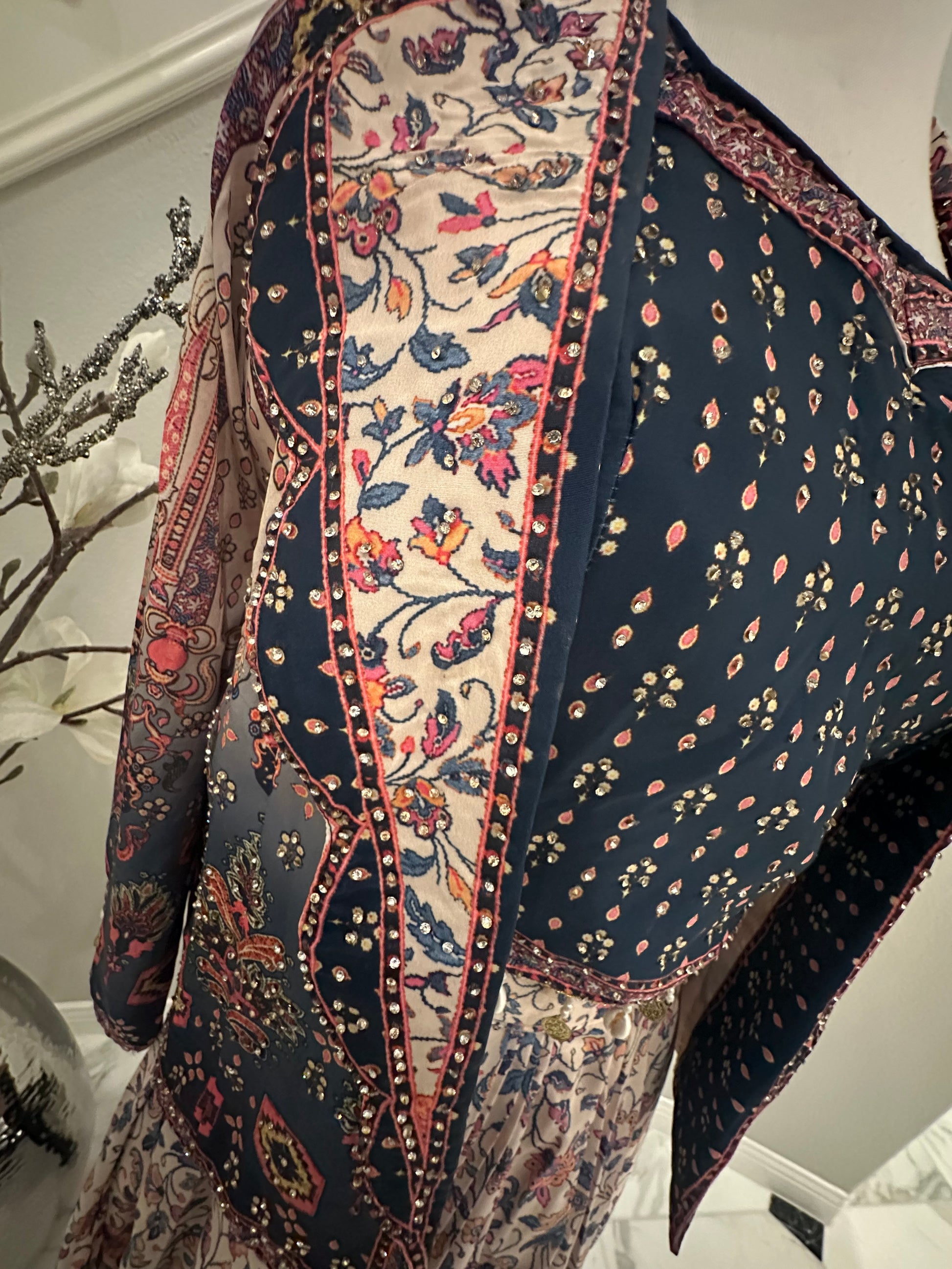 Shine bright with this beautiful 3piece ensemble in pure silk and digital floral print with rhinestone work all over.  The set includes dhoti style skirt, rhinestone embellished crop-top and jacket with front lapel

Size available 40 with margin