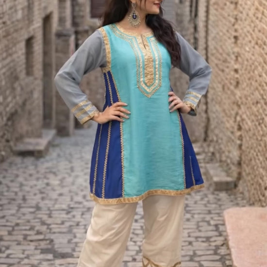 Kareena Kapoor inspired traditional outfit with a blue and green top with gray sleeves and beige pants.